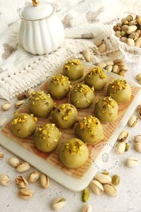 Pistachio truffles on a white marble board