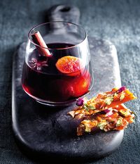 Kick off your winter dinner party with this piping hot mulled wine whiskey, served alongside a sweet and salty brittle.