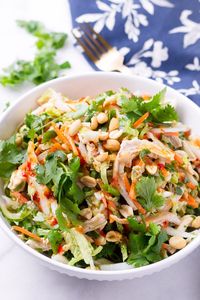 Easy Crunchy Thai Chicken Salad! Delicious Thai style chicken salad, packed with napa cabbage, cilantro, scallions, carrots, and peanuts. Dressed with a sweet chili dressing #cookingformysoul