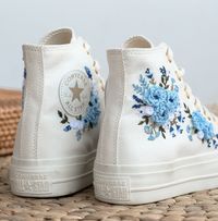 "White Platform Converse High Top embroidered with pink roses for Wedding shoes are inspired by the beautiful bridal bouquet. With many years of experience embroidering wedding shoes for the bride, this time I was really happy to receive a personalized canvas sneaker embroidery design for a very special guest. They sent me wedding photos and sweet blue bouquets of flowers. I love them and also love this custom embroidered item. If you also need a pair of Converse Wedding Shoes or a pair of Vans Shoes for the bride, please message me with wedding photos. I will design and embroider a special pair of wedding shoes for your wedding anniversary. * Product details: ''Converse Platform hand embroidered Blue Flowers'' Shoe Type: Converse Platform Shoe color: 16. White Gold Chain Price includes: S