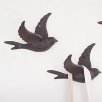 Beautiful and functional, these adorable flying bird hooks, made of cast iron, are perfect for hanging scarves and jewelry with a bit of vintage whimsy. Sold individually- minimum of 2 Measures 6.5"L x 4"D x 4.5"H