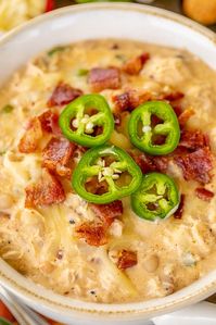 Chicken Jalapeño Popper Chili - the BEST of the BEST chicken chilis! SO good and ready to eat in under 20 minutes! Rotisserie chicken, white beans, jalapeños, chicken broth, onion, garlic, cumin, chili powder, half-and-half, cream cheese. Top with some extra bacon, jalapeños and pepper jack cheese. Makes a ton. Freeze leftovers for a quick meal later. #chili #jalapenos #chicken #mexican #rotisseriechicken