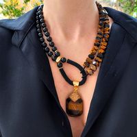 Tiger eye and black onyx layered necklace set with pendant. Chunky statement natural gemstone beaded necklace for women. Large brown black handmade necklace with big bead and gemstone. Big bold bohemian bright necklace in gold color are suitable for an casual look, evening look and for a holiday. These necklace will be a good Mothers day, anniversary, wedding or birthday gift for women, mom, wife, girlfriend, sister or daughter. Women's necklace with natural stone. It emphasizes the beauty of yo