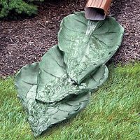 I think this might be a DIY project with concrete and some leaves for making the imprints!  Great alternative to ugly plastic downspout extensions. :-)