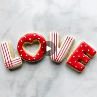 Mary Mansfield on Instagram: "Bringing back an oldie, but cutie set of LOVE cookies for Valentines or any time. I edited this one quite a bit for those who don’t have much time, lol. The base flood was still wet, but you can choose your own adventure with this one. Wet on wet or wet on dry. Spread some love today my friends. ❤️ #cookievideo #cookiedecoratingvideo #cookiedecoratingtutorial #royalicing #valentinescookies #royalicingcookies #decoratedcookies #icingcookies #decoratedsugarcookies #cookiedecorating #cookiesofinstagram"