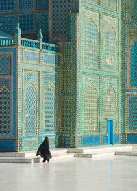 A woman walking in chador at the Blue Mosque, a shrine to Ali, in the city of Mazar-i Sharif, Afghanistan.