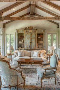 "Weathered wooden cabinets tell stories of past elegance, bringing a sense of time-honored charm to the French country living room. The distressed finishes add character and depth, seamlessly blending with the rustic yet refined aesthetic". #frenchcountry, #livingroom, #sofa, #accentchair, #coffeetable, #cabinet.    image: Hello Hayley