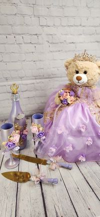 Packages: Complete package includes: 🧸 Quinceanera Bear or Doll (Includes bear or doll, Dress, Petticoat, Jewelry, Metal Tiara, Bouquet, Doll stand, Personalized ribbon) 👸🏻 Tiara upgrade for Bear/Doll  🧸 Doll stand for the Bear/Doll  ️ Kneeling Pillow  👸 Tiara Pillow 📖 Guest Book 🖋️ Pen 📕Bible 🕯️Candle 📷Photo Album 💵Card/Money Box (Acrylic also available for additional cost) 🥂🍾Small Brindis Champagne Set (2 glasses & 1 bottle) 🍰Cake Serving Set ✍🏻 Personalization on items ✍🏻 Ribb