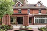 Cast Corbel House by Grafted features handcrafted red-concrete details