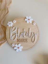 BIRTH ANNOUNCEMENT welcome the birth of your baby with our stylish daisy modern wooden birth sign. Great for photo props of announcement to family and friends baby first name will be cut from colored acrylic of your choice and middle and last name will be engraved Size• 6”h oval plaque.pictured• Engraved on 1/8 Birch Plywood. • Product is intended for photo props • Mockups are not sent unless requested, please ensure to carefully check spelling and details before completing your order. • Sign are made to order.• Slight variations in color may be a result due to the natural nature of the wood. • This listing is for the wooden sign only, PHOTO PROPS NOT INCLUDED.