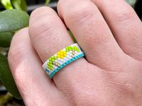 Miyuki 11/0 Delica seed bead ring with waves, palm trees and sun, woven together using the even count peyote stitch. I use my own version going back on itself in each row so it is very strong and tight. Made with Fireline thread so it will not stretch.  🌟There is a matching bracelet!! You can find it here! https://www.etsy.com/listing/1264611982/miyuki-110-delica-seed-bead-bracelet-in?click_key=93dd39b54531397160e9a0707d5b10e1d792373b%3A1264611982&click_sum=5537009e&ref=shop_home_active_25&frs=