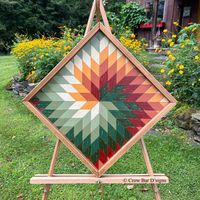 Warm and earthy colors make this spiraling star barn quilt perfect for accenting your Autumn inspired decor.  Hang this on your porch, in your entryway, or above the fireplace mantle for a pretty display. This handcrafted wall art can be hung in a variety of ways on point or as a traditional square. Wooden Barn Quilt - Swirling Star * Measures 24 1/2" x 24 1/2" diagonal or 17 1/2" 17 1/2" square * Hand painted in golden yellow, burnt orange, deep red, and earthy green hues * Wood Framing * Metal hangers on back for easy wall hanging * Ready to ship in 1-3 business days *Free Shipping USPS Priority Mail This handmade wood wall art is created with premium cedar that is locally sourced here in Vermont.  Each wood cutout of the inlaid geometric design is hand painted and lightly distressed to