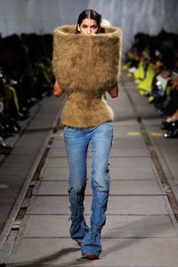 An AW24 top in camel on a double-face knit and corset base and wrapped jeans in blue stonewash denim.  From the Alexander McQueen Autumn Winter 2024 Show by Seán McGirr.