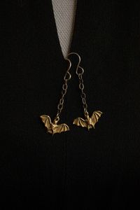 Wonderfully detailed raw brass bats dangle from solid sterling silver chains and ear hooks, just in time for Halloween! These earrings are lightweight and easy to wear for any spooky or festive fall occasion. I added a patina to enhance the details and to create a more antique look. Each earring is approximately 1 3/4 inches long including the ear hook and weighs .03 oz (.8 g) ✦ C A R E - I N S T R U C T I O N S ✦ Each creation is lovingly hand crafted with meticulous attention to detail, aesthe