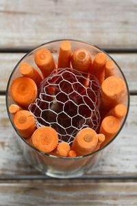 DIY Easy Carrot Flower Arrangement Tutorial using Chicken Wire | ©homeiswheretheboatis.net #spring #easter #tablescape #diy #flowers #centerpiece #bunnies