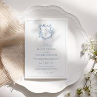 Formal & elegant crest monogram blue wedding invitation.