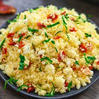 This Couscous with Sun-Dried Tomatoes is fluffy and flavorful with the tart sweetness of the tomatoes going perfectly with the rich buttery grains. You'll love how simple and delicious it is.