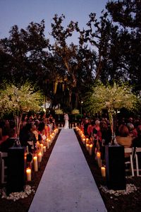 Candle light wedding ceremony in NOMA's Besthoff Sculpture Garden | Romantic wedding ceremony, outdoor wedding ceremony, New Orleans wedding, places to get married in new orleans