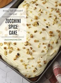 Zucchini spice cake recipe by Zucchini Zone. Zucchini spice cake is filled with shredded zucchini and cozy fall spices for the most tender and moist sheet cake. Topped with velvety cream cheese frosting and chopped walnuts, this will be your new go-to fall cake recipe. #zucchinicake #zucchinispicecake #spicecake #falldesserts #fallcake #autumn #recipe #homemade #creamcheesefrosting