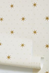 The stars are aligned with this celestial-inspired wallcovering that lends a dazzling touch to your decor. About York Wallcoverings Recognized as America’s oldest and most prolific wallpaper manufacturer, York Wallcoverings continues to produce from its historic 1895 location in the heart of Pennsylvania’s Susquehanna Valley. The factory still operates its rare, turn-of-the-century presses to this day while utilizing modern, digitally innovative processes to create wallpaper designs both distinct in quality and craftsmanship. Need help choosing the right wallpaper for your home? Read our guide to transforming your walls – and your space. | Stella Star Wallpaper by York Wallcoverings in Beige at Anthropologie