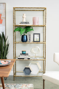 Classic in design with a dash of textural appeal, the Signature Design by Ashley Ryandale bookcase provides endless possibilities for displaying your decor. Five shelves offer the perfect perch for potted plants, books, or your favorite framed artwork. The frame's antiqued brass-tone finish has a rustically luxe look that remains versatile, suiting spaces from casual to contemporary.