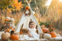 Create enchanting autumn photos with our "White Teepee Tent with Fall Flowers" digital backdrop. This charming scene features a white teepee tent beautifully decorated with fall flowers, pumpkins, and a cozy blanket, set in an open field. Perfect for autumn photo shoots, mini sessions, and kids photo composites, this backdrop adds a touch of seasonal magic to your photography. Download now and capture the warmth and beauty of fall with this delightful backdrop--a must-have for any autumn photo c