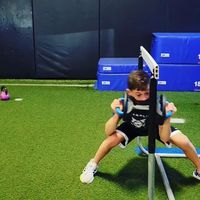 Youth athletes utilizing the MoveStrong DynaBell, multi-handle functional fitness dumbbell, while performing lateral lunge duck unders. Great functional strength movement for athletes of all ages.