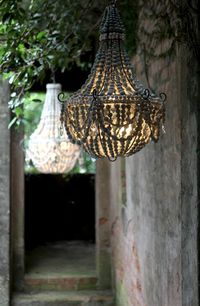 A decorative planter hook off the front of the house with a lantern, like my star one filled with white lights, or an outdoor chandelier. .....Crush Cul de Sac