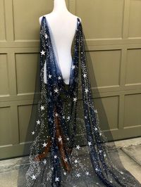 Save yourself time and money by downloading your free "Veil Guide" by copying and pasting this link: https://mailchi.mp/7293feff861f/veilguide Be ethereally and magically inspired with this sparkly celestial star cape / veil. A modern take on the classic wedding veil, this softly draped, adjustable cape veil was designed for brides who want to show off a dress with a low back or unique back detail. Made from soft silk blend fabric, this detachable cape / veil can be work in many different ways.