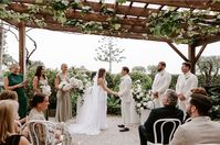 Beautiful ceremony under the graoevine at Fig Tree Restaurant Byron Bay on a rainy day