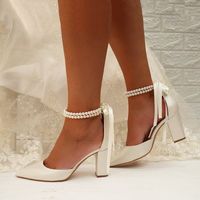 Elevate your bridal look with Pearl Ribbon Tie Block Heel Point Toe Wedding Heels, exuding elegance and charm. Adorned with delicate pearls and featuring a sophisticated point toe design, these heels are secured with a graceful ribbon tie, adding a romantic touch to your ensemble while ensuring comfort and grace as you walk down the aisle.