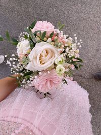 Pink and white flowers with babys breath. Bouquet with light pink dress.