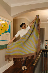 Totally immerse yourself in the warmth of the Demeter Beaded Shawl. Named for the Greek goddess of the harvest, this jumbo blanket shawl is here to cocoon you in the feels of autumn. Thin stripes of coordinating colors transition into a border of textured stitches, and finished with a twisted fringe border. If drama is what you want, drama is what you get in this triangle shawl.

The Demeter Beaded Shawl pattern is part of the Happy Place pattern collection, designed to complement Apricity Yarn.