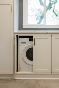 When we designed this kitchen, the homeowners wanted to convert their previous laundry room area into an extension of the kitchen. What was once a dark utility room is now a sunny breakfast nook with hidden laundry. Check out the counter above the w/d combo, you'd never guess it was perfect for folding laundry! 
#hiddenlaundry #creativedesign #tallahassee #renovation #trendykitchens #modernkitchen #uniquedesign #florida #remodeledkitchen 