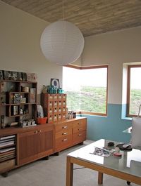 Paper lantern, wood ceilings, modern walnut sideboard unit and great storage solutions for this modern minimalist workspace