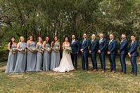 Bridesmaids in dusty blue dresses mismatched. Groomsmen in navy blue suits. See more from this fall outdoor wedding in Fort Collins, CO on the blog. #dustybluewedding