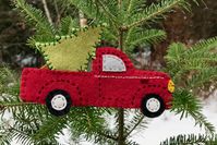 The vintage pickup truck carrying a tree is such a popular theme right now that I’m creating a Christmas wreath around this wood version I designed. It was only after I had it cut out and pai…