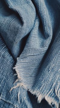 Denim Texture Close-up: Close-up image showcasing the detailed texture of a blue denim fabric with frayed edges and visible weaves. #denim #texture #fabric #blue #close-up #material #textile #cotton #stockcake https://ayr.app/l/JsCa