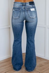 Details: Rayna Risen Flare Jeans Intentional Distressing Button Fly Closure Fading/Whiskering Flare Leg Bottom Great STRETCH MID RISE Available in 2 Washes Rise: 9.25" Inseam: 33" Material: 92% Cotton, 6% Polyester, 2% Spandex We are recommending TRUE to size for most comfort & sizing down if between sizes! 1XL - Sizes (16-18) 2XL - Sizes (18-20) 3XL - Sizes (20-22)