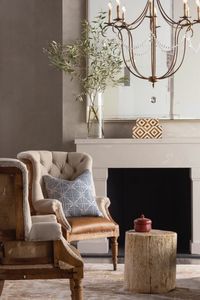 Deconstructed tufted chairs and a Gold Crystal chandelier make for a comfortable and inviting sitting area. #frenchcountry, #accentchairs, #armchairs, #chandelier