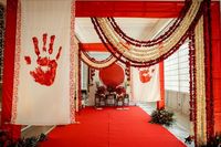 In our tradition, the welcoming of the bride into the house is often likened to the arrival of the goddess Laxmi❤️  “Chaap Tilak” theme thus embodies the essence of the welcoming of goddess laxmi, emphasizing acceptance, respect, and the beginning of a new journey filled with love and devotion.  We took the hand prints of the bride & made big scrolls out of it to make it look more personalised ❤️  Design & Concept. : @_designellaa