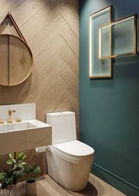 Combine touches of contemporary decor with more rustic elements to create a unique modern bathroom design. This dark green feature wall looks stunning against the wood effect wall tiles. #wholesaledomestic #bathroomidea #bathrooms #bathroominspiration #bathroomdecor #bathroomdecorideas #bathroomdesign #dreambathrooms #modernbathroom #modernbathroomdesign