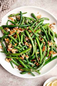 Green Beans Almondine is buttery, garlicky, and nutty. This classic French side dish is quick and easy to make, and loaded with flavor and texture. | aheadofthyme.com