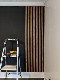 Installing-slat-wall-on-black-wall-using-finish-nailer