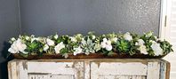 This neutral arrangement is designed with assorted succulents, real touch roses, hydrangea and gardenia.  39" long 7" tall  8" wide 