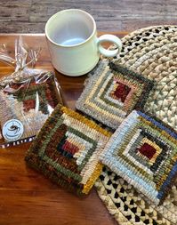 This mug mat measures 4 1/2 square and is hooked with 100% wool. Its great to use as a gift combined with a favorite tea or coffee! It repels water and will protect the surface of your table. The pattern in the square is called Log Cabin and is a favorite among quilters