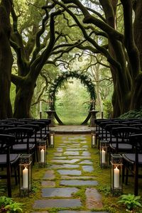 Step into a magical world with this 'Lord of the Rings'-inspired wedding venue set in an enchanting forest clearing. Surrounded by towering ancient trees, this venue features a rustic wooden arch adorned with ivy and white flowers, perfectly capturing the essence of Elvish elegance. The stone pathway, lined with lanterns and leading to the ceremony space, is flanked by dark wooden chairs, creating a serene and timeless atmosphere. Ideal for couples seeking a nature-inspired, fantasy-themed wedding that feels like stepping into Middle-earth