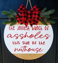 Who doesn't love National Lampoon's Christmas Vacation?! A little twist on our original, wood grain Christmas Vacation sign (separate listing, don't forget to look at that one too!). This is the perfect Christmas door hanger sure to make all your friends, family, and neighbors laugh. This funny door hanger would be a great gift for family or friends. DETAILS: 18”x18”x1/2” REAL Birch wood used Greenery/bow are attached with glue & staples Jute rope on the back for hanging is attached with sta