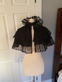 "Extremely cool turn of the century capelet. Feathery thick lace all over with beading and subtle pattern silk. Not totally perfect - normal wear, missing some beads, and some browning and exposed threads on the black lace. Being sold as is Women's XS/small 13\" neck circumference 13\" shoulder to hem"