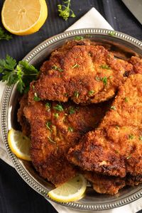 Learn how to make crispy turkey schnitzels with a golden coating using simple ingredients like turkey breast, breadcrumbs, and Parmesan. Serve them hot or use them to make sandwiches or burgers.